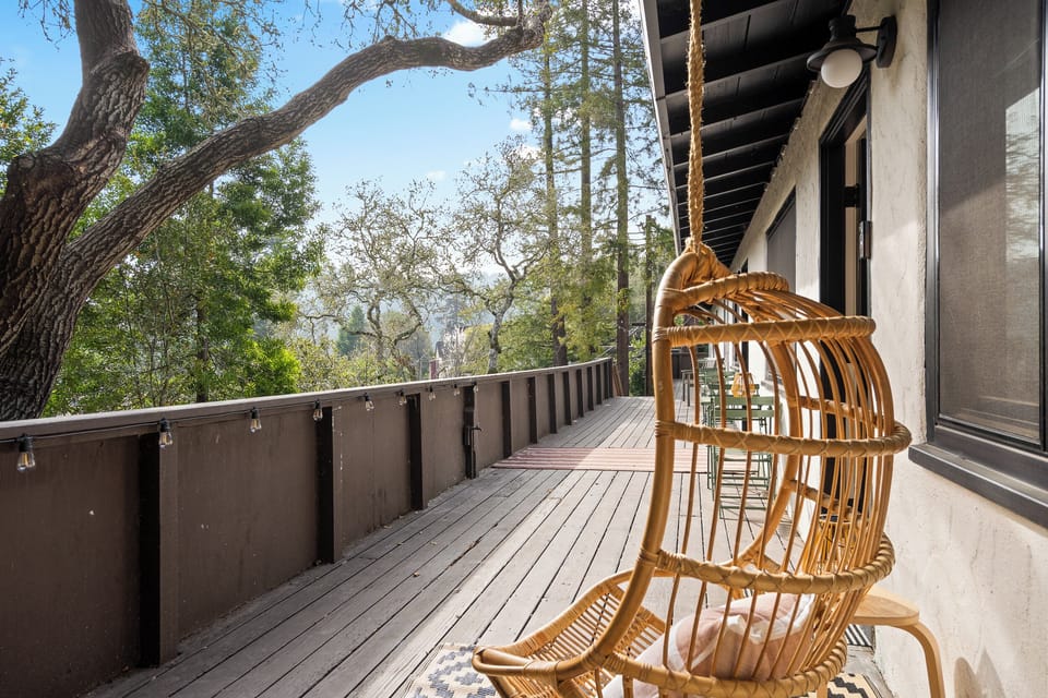 Deck area with hanging chair — perfect for coffee or sunset wine