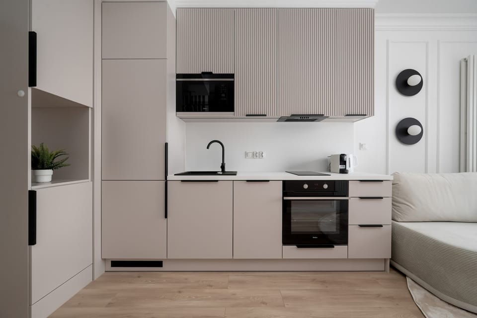 The sleek design of the kitchenette blending seamlessly with the living area.