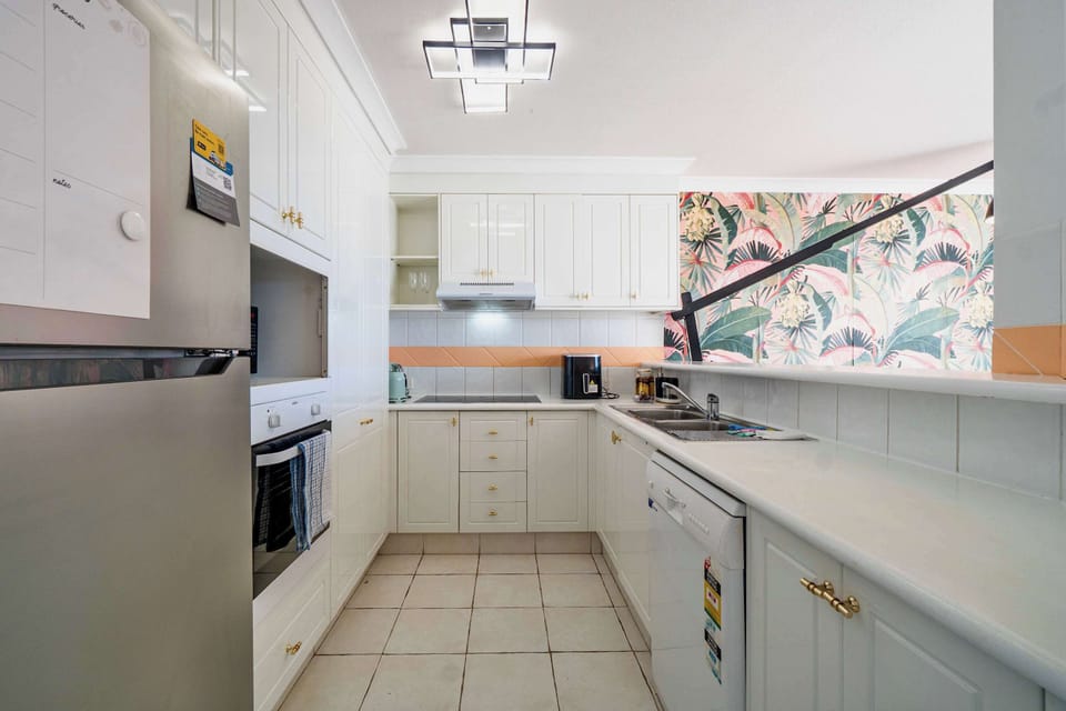 Kitchen - full kitchen with plates, bowls, cups, cooking pots and pans, oven, microwave, fridge, coffee pod machine, cutlery and dishwasher