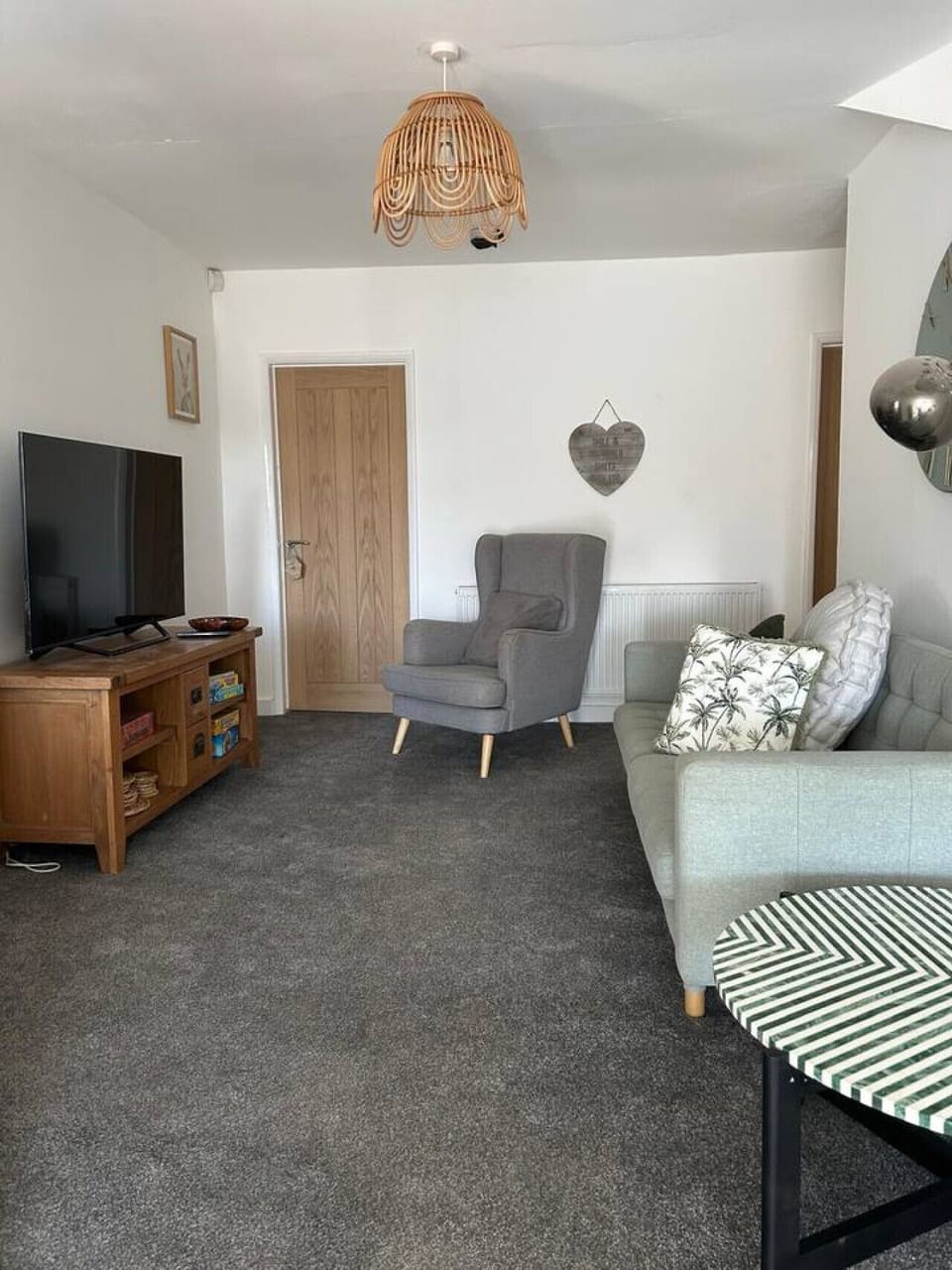 Dining area with a table, chairs, and glazed doors letting in natural light