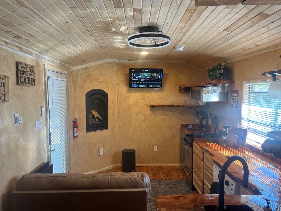refrigerator, gas fireplace and 24 inch smart tv