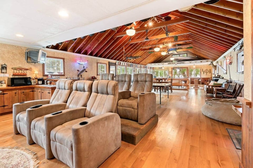 Spacious entertainment lounge with theater seating, vaulted ceilings, and plenty of room to relax or gather with friends and family