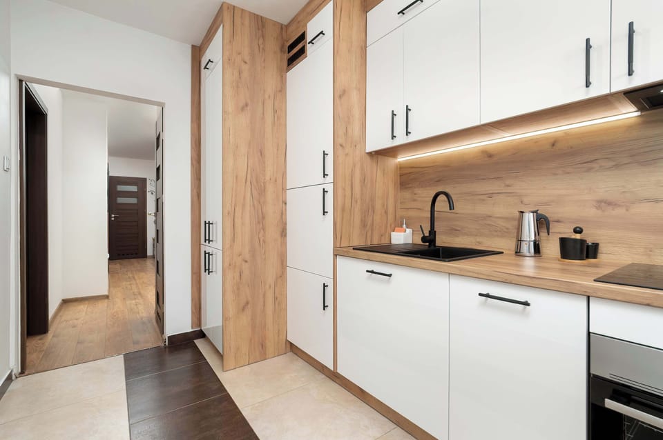 The kitchen's sleek design includes all necessary cookware and utensils.
