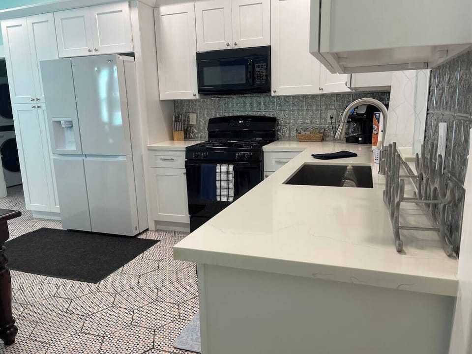Full kitchen with cooking supplies.