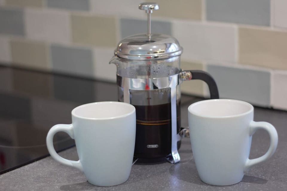 Start the day with a cafetière coffee and two mugs on the worktop.