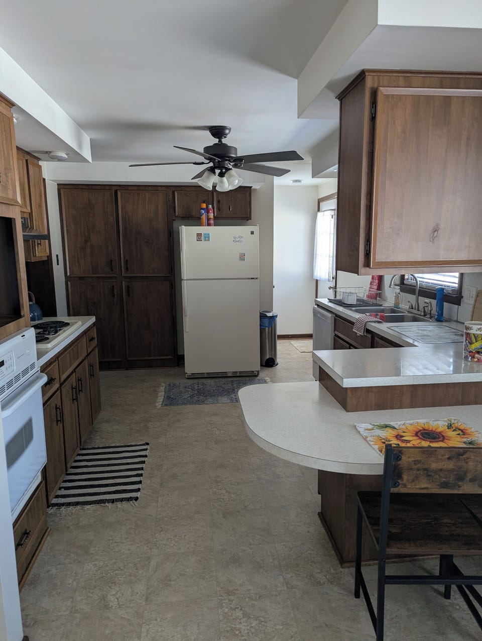 Kitchen with ceiling fan and breakfast counter