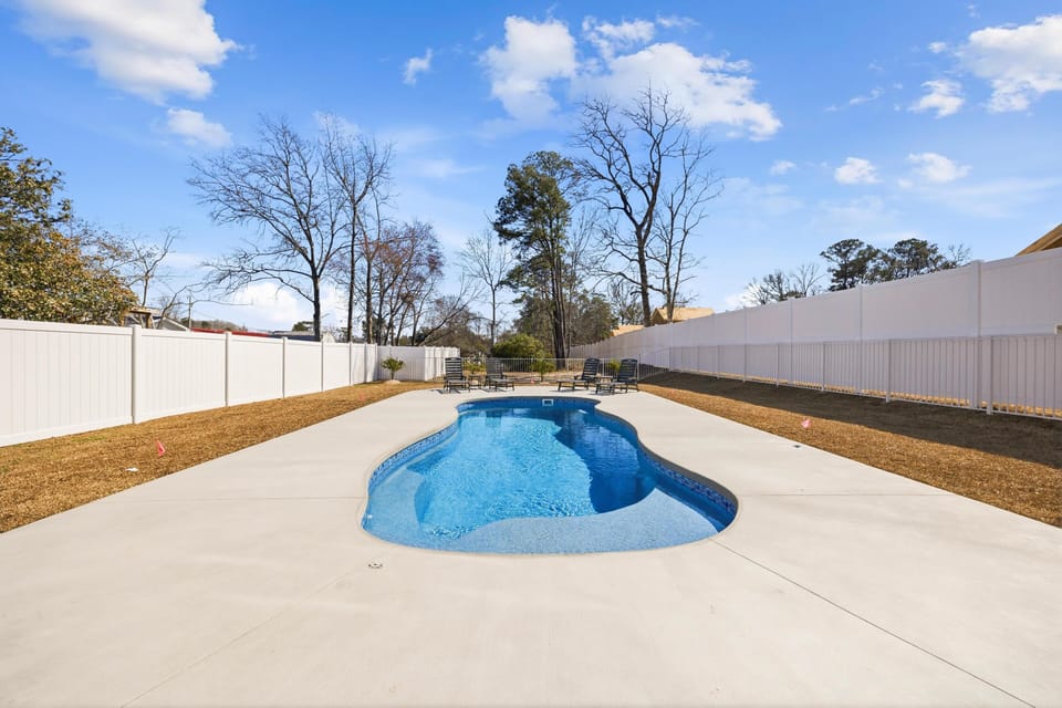 Private backyard pool with spacious sunbathing deck