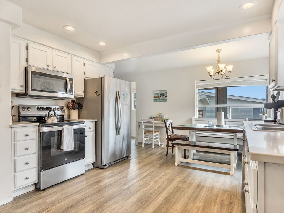 Stainless steel appliances, quartz counters, and ocean view from the kitchen tab