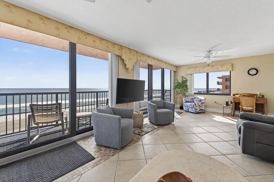 Bright, spacious living room overlooking the shoreline.