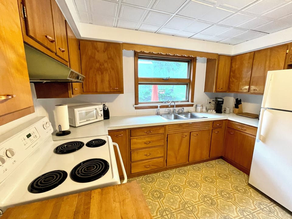 Spacious kitchen complete with a full range, refrigerator, microwave, and coffee