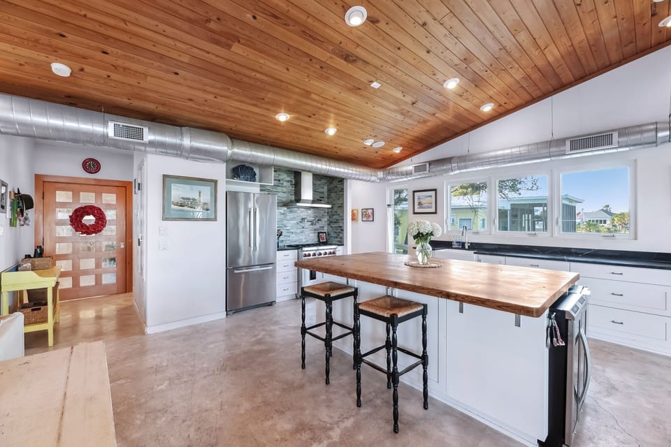 A fully equipped kitchen centered around a generous island—perfect for gathering, prepping, and lingering a little longer.