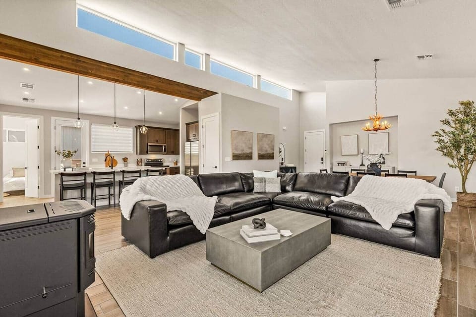 Relax in the spacious living room with an oversized leather sectional and a cozy wood-pellet stove.