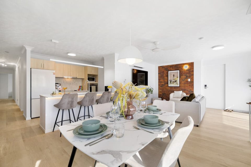 Open plan dining and kitchen area with breakfast bar and coffee machine