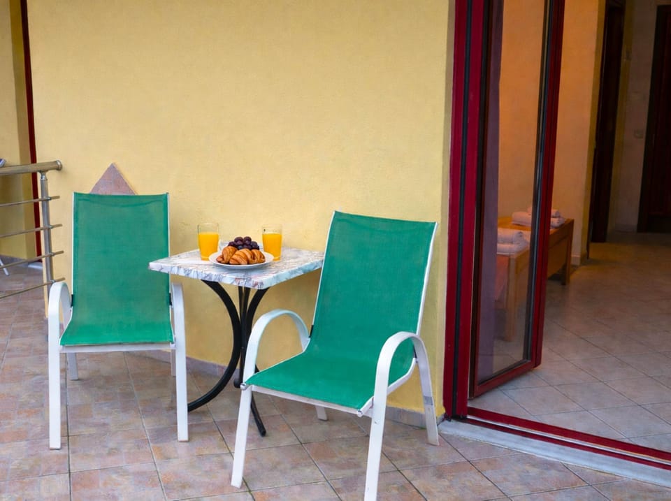 Outdoor patio table for light meals or coffee, offering a peaceful setting in a quiet central neighborhood.
