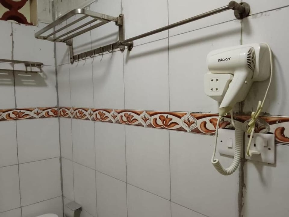 Shower, hair dryer, slippers, towels