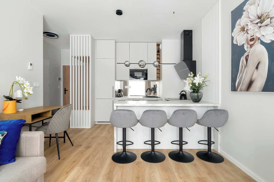 Modern kitchen island with seating and open view to the living area.
