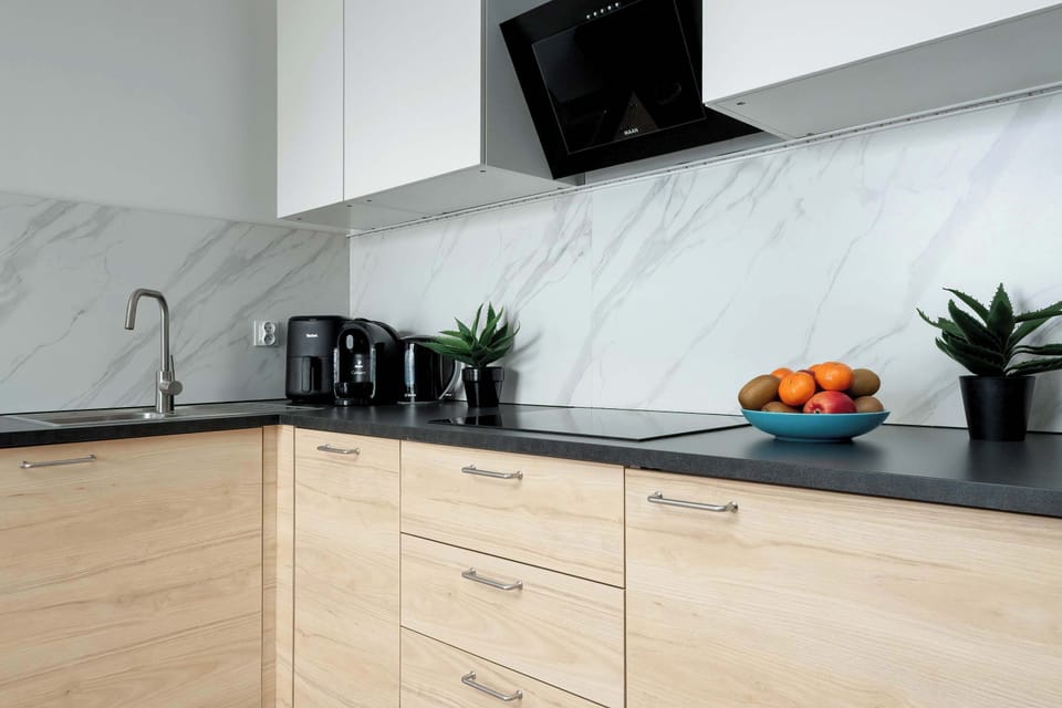 Modern kitchenette with countertop, coffee maker, kettle and essential kitchen equipment for everyday use.