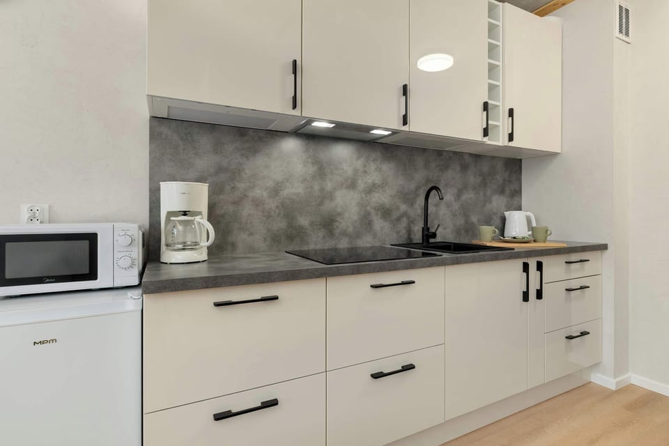 Fully equipped kitchenette with cabinets and appliances.