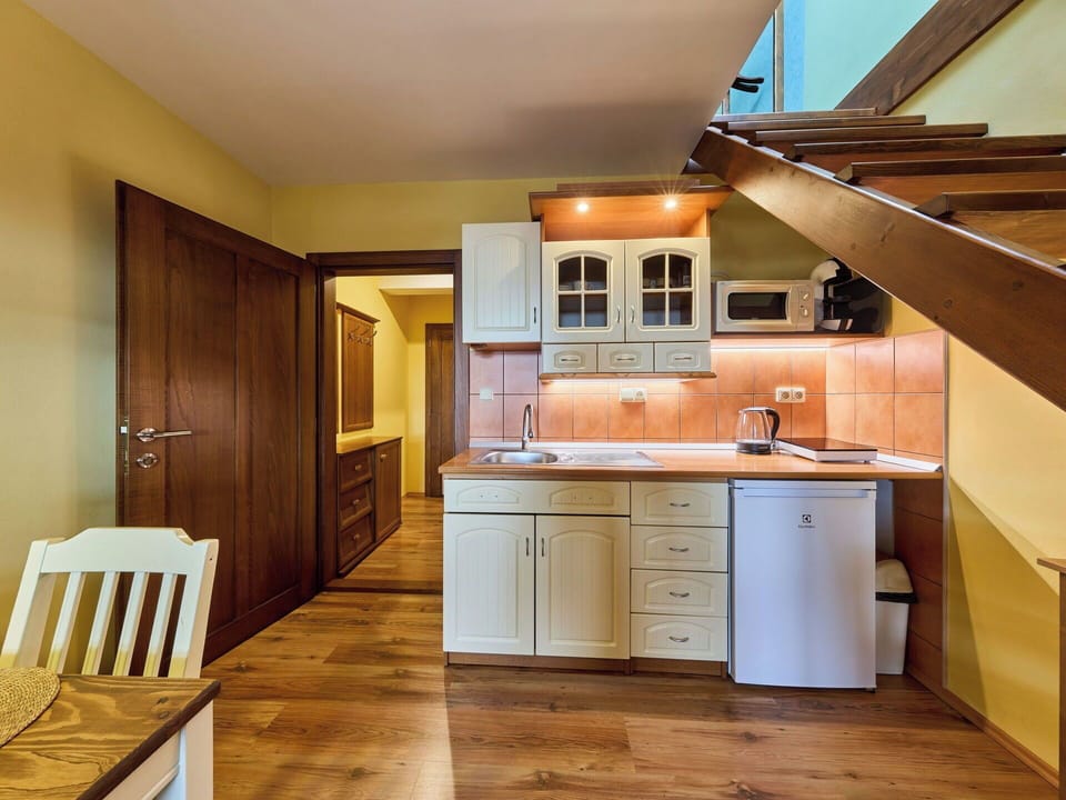 Interior Design, Wood, Flooring, Floor, Furniture, Ceiling, Cabinetry, Kitchen, Major Appliance, Room
