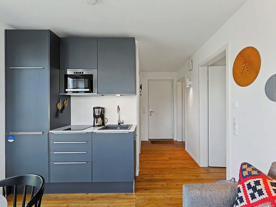 Furniture, Kitchen, Interior Design, Flooring, Kitchen Appliance, Countertop, Floor, Wood, Major Appliance, Cabinetry