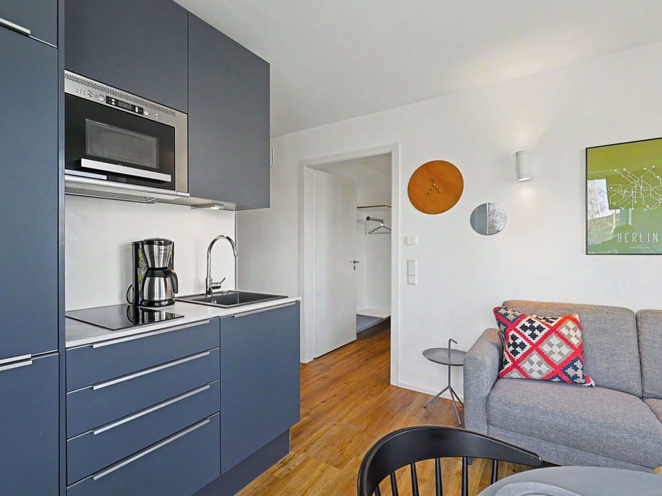 Furniture, Interior Design, Flooring, Kitchen, Countertop, Floor, Wood, Cabinetry, Kitchen Appliance, Room