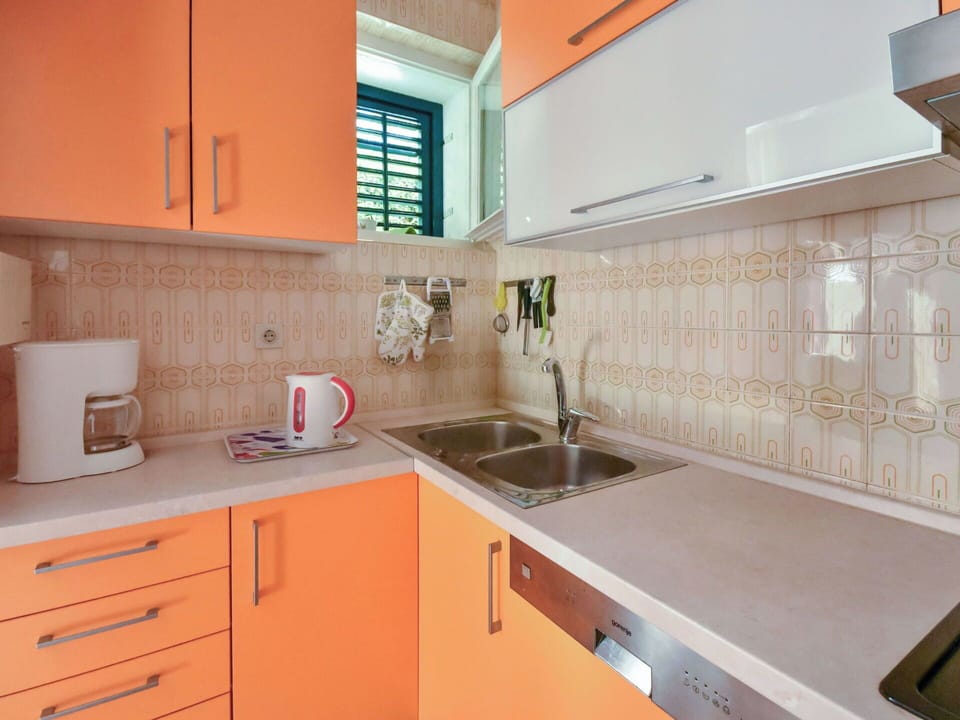 Kitchen, Countertop, Kitchen Sink, Kitchen Appliance, Cabinetry, Plumbing Fixture, Major Appliance, Interior Design, Sink, Flooring