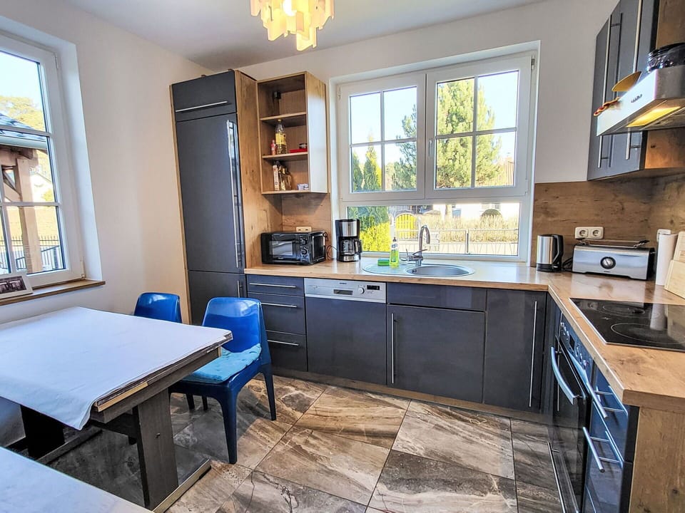 Furniture, Kitchen, Countertop, Kitchen Appliance, Cabinetry, Flooring, Interior Design, Major Appliance, Wood, Floor