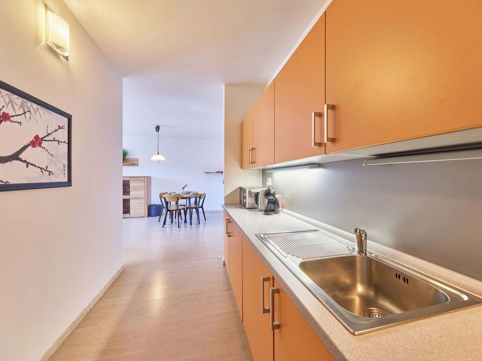 Flooring, Interior Design, Wood, Ceiling, Floor, Kitchen, Countertop, Room, Lighting, Apartment