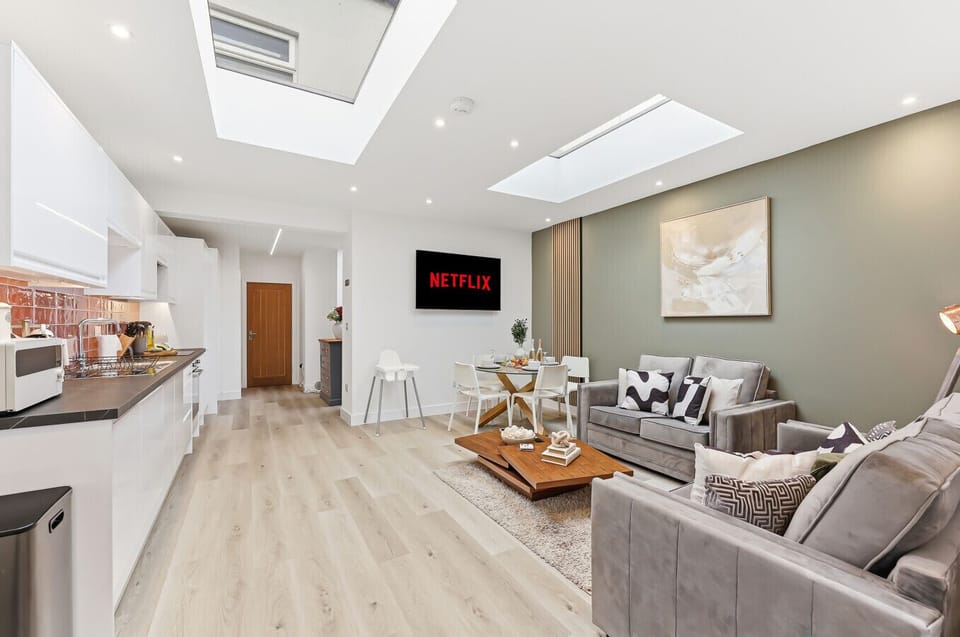 The open-plan kitchen and living area features skylights, creating a bright and airy space.