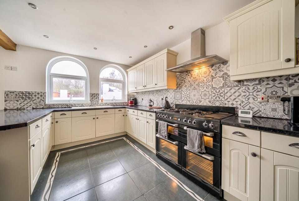 Cook up a feast in the spacious kitchen with a range cooker and patterned tiling.