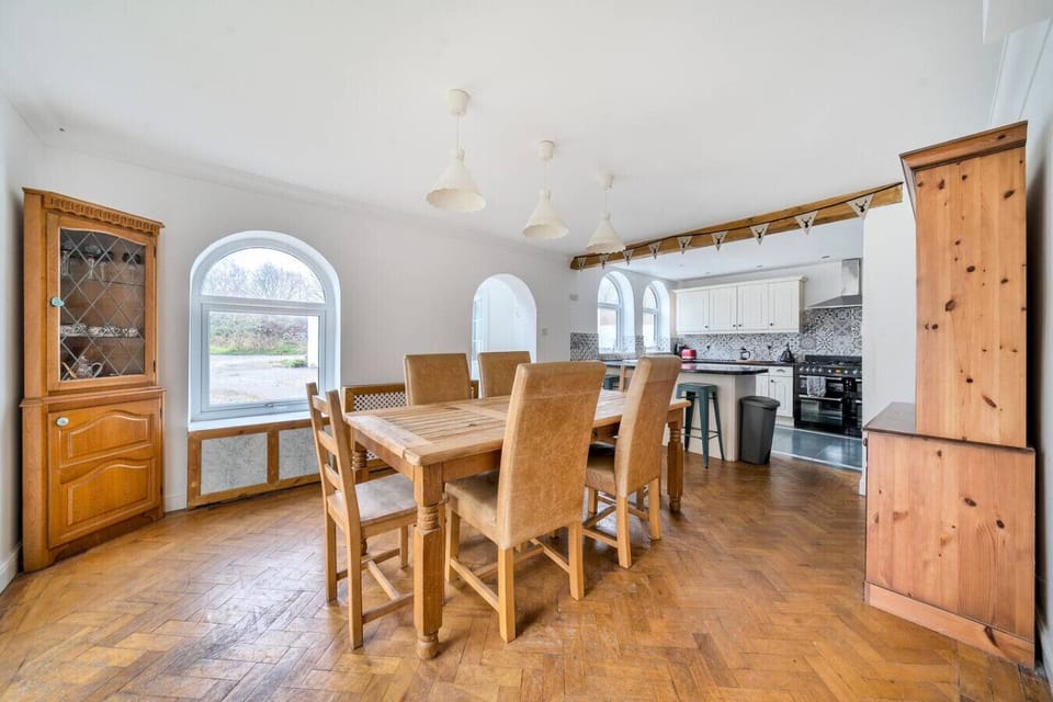 Dine in the open-plan space with a large table and seating for groups.
