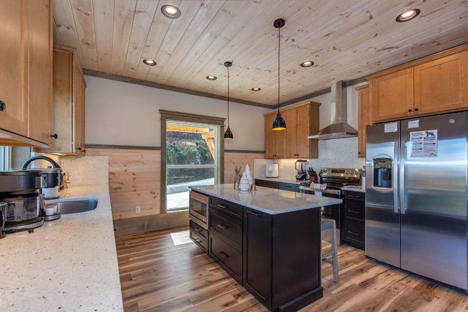 Cook your favorite meals in this beautifully designed kitchen featuring rustic wood beams, modern appliances, and spacious island perfect for gatherings.