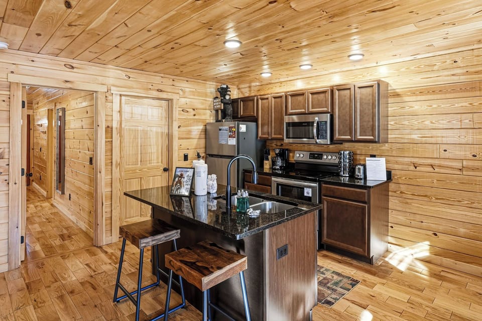 Your fully-equipped kitchen features granite countertops and rustic wooden warmth, perfect for preparing memorable meals together.