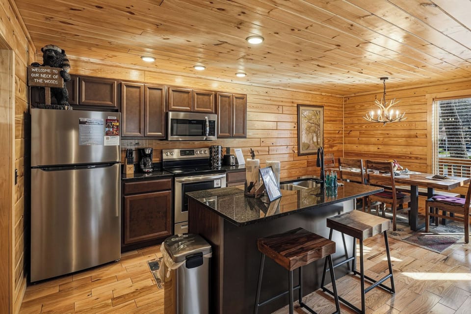 Gather around this spacious kitchen island where you'll prepare meals together, surrounded by warm wood beams and modern appliances.