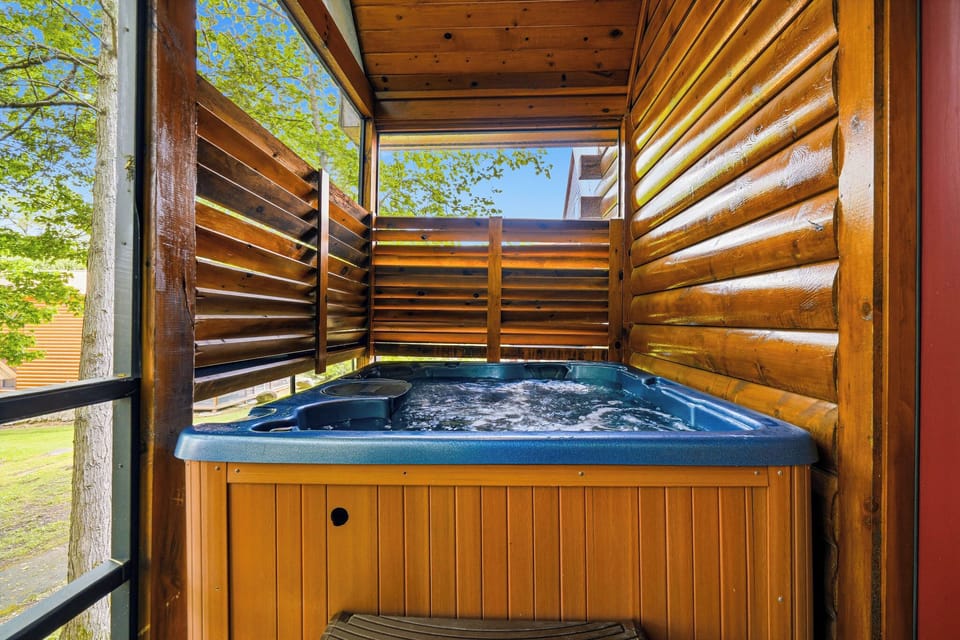 Your private hot tub sanctuary awaits, sheltered by warm wood screens for intimate relaxation under open skies.