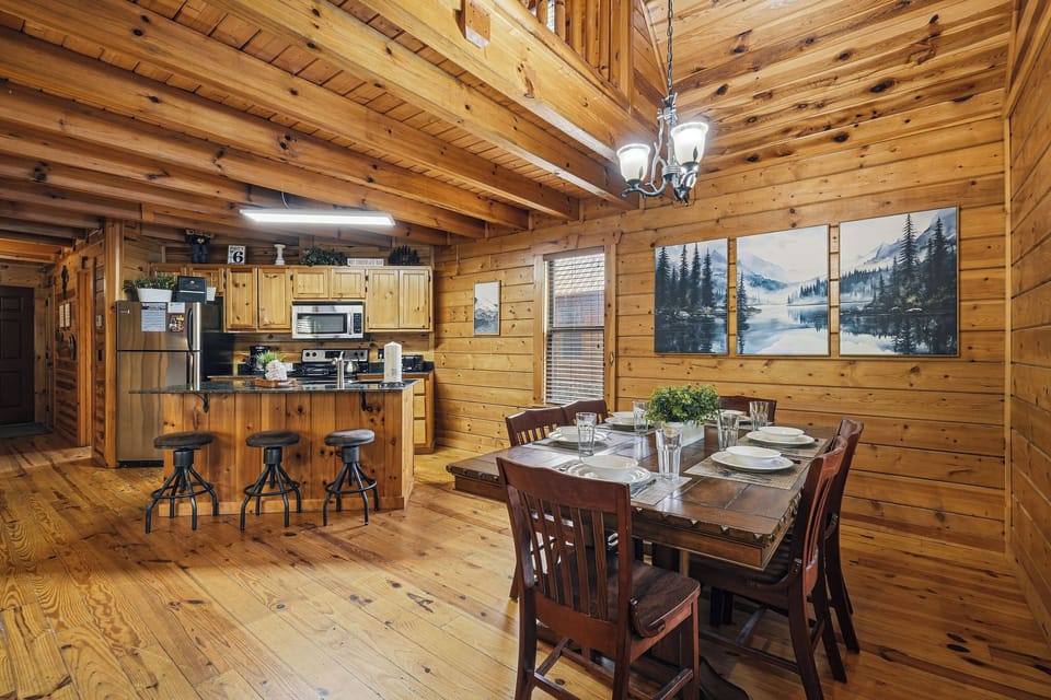 Step into your cozy log cabin retreat where rustic charm meets modern comfort. The open-concept kitchen and dining area invite memorable meals together.