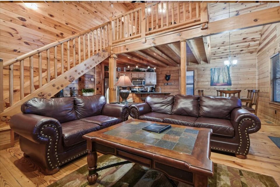 Sink into plush leather sofas surrounded by warm wood walls and beams that create your perfect mountain retreat atmosphere.