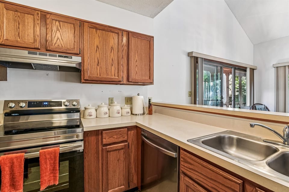 Your fully equipped kitchen features warm wood cabinetry, stainless appliances, and ample counter space for preparing meals during your stay.