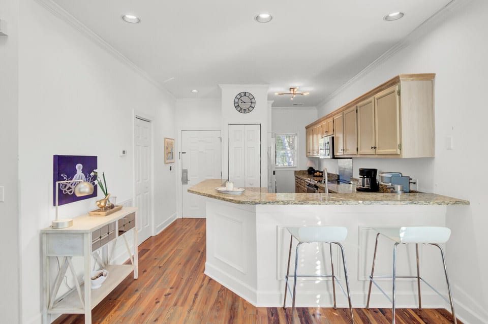 Your bright open kitchen flows seamlessly into the living space, featuring granite countertops and breakfast bar seating for casual dining.