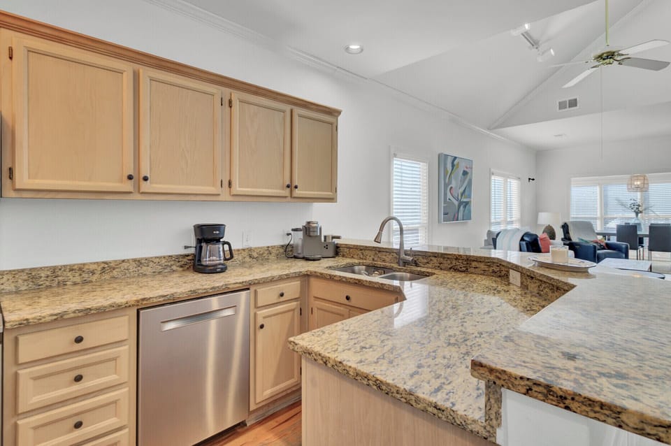Your spacious kitchen features granite counters, modern appliances, and an open layout perfect for preparing meals and staying connected.