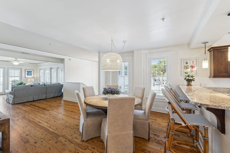 Gather around your spacious dining table while natural light streams through windows, connecting seamlessly to your cozy living space.