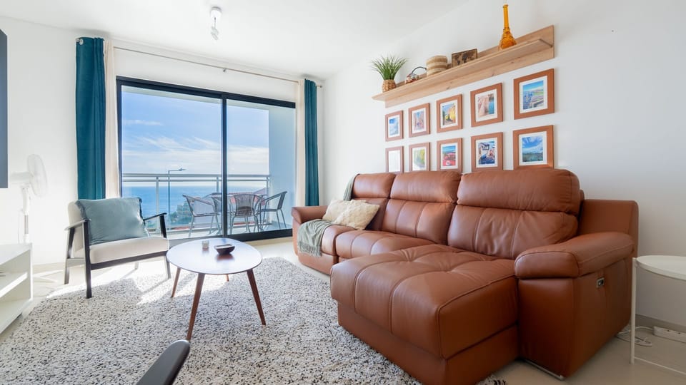 Unwind in this cozy lounge at Amethyst by LovelyStay, featuring stylish décor, air-conditioning and access to the balcony with ocean views. #RelaxInStyle #LovelyStay #MadeiraViews