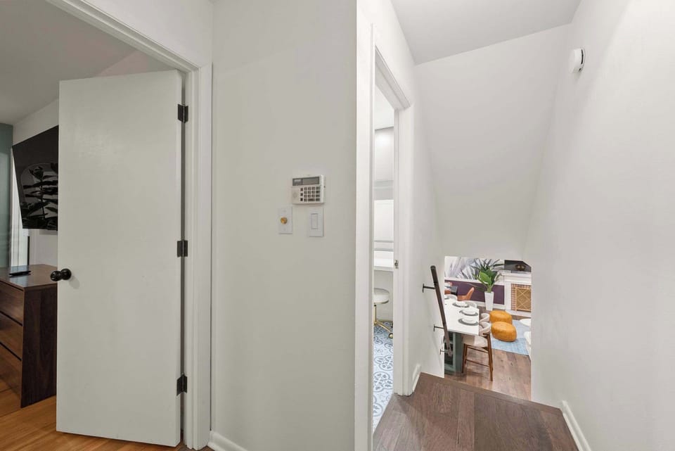 Clean hallway view w/ doors leading to bedrooms & shared spaces.