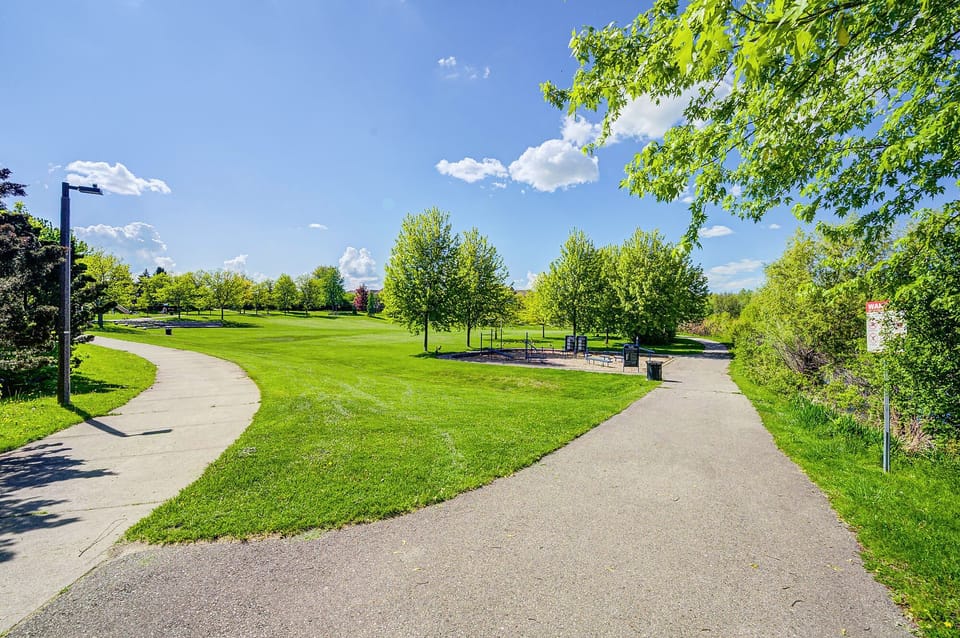 Scenic park access with walking paths, green space, and peaceful outdoor seating