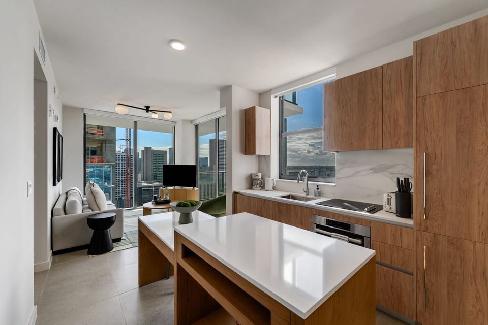 Open kitchen layout with island seating and city views.