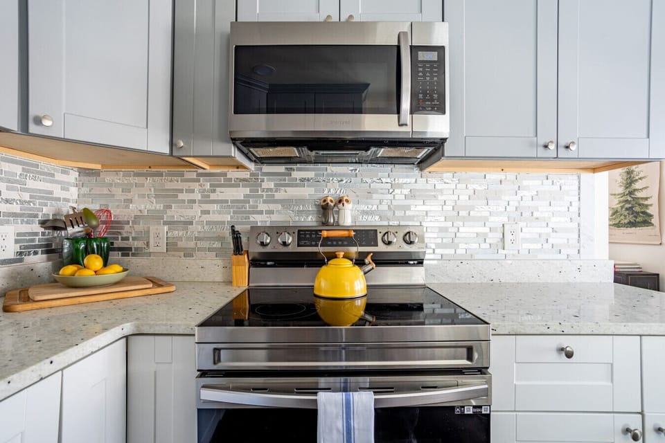 The kitchen includes an electric stove and new appliances