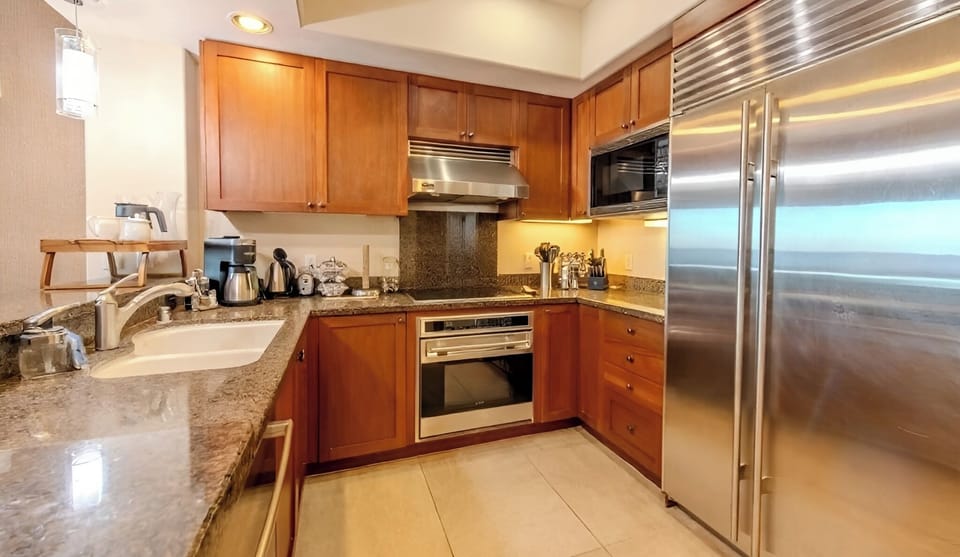Prep fresh island meals with stainless appliances and granite counters.
