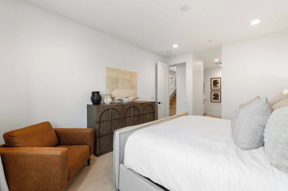 Spacious bedroom with seating area and natural light