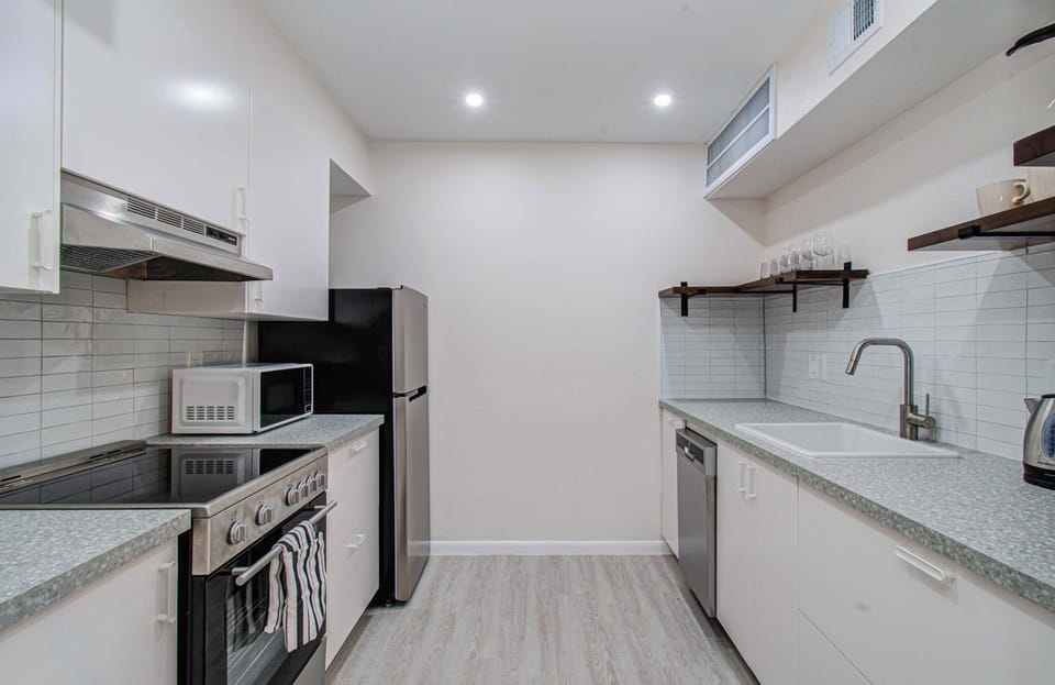Fully equipped modern kitchen with sleek appliances and plenty of counter space for home-cooked meals.