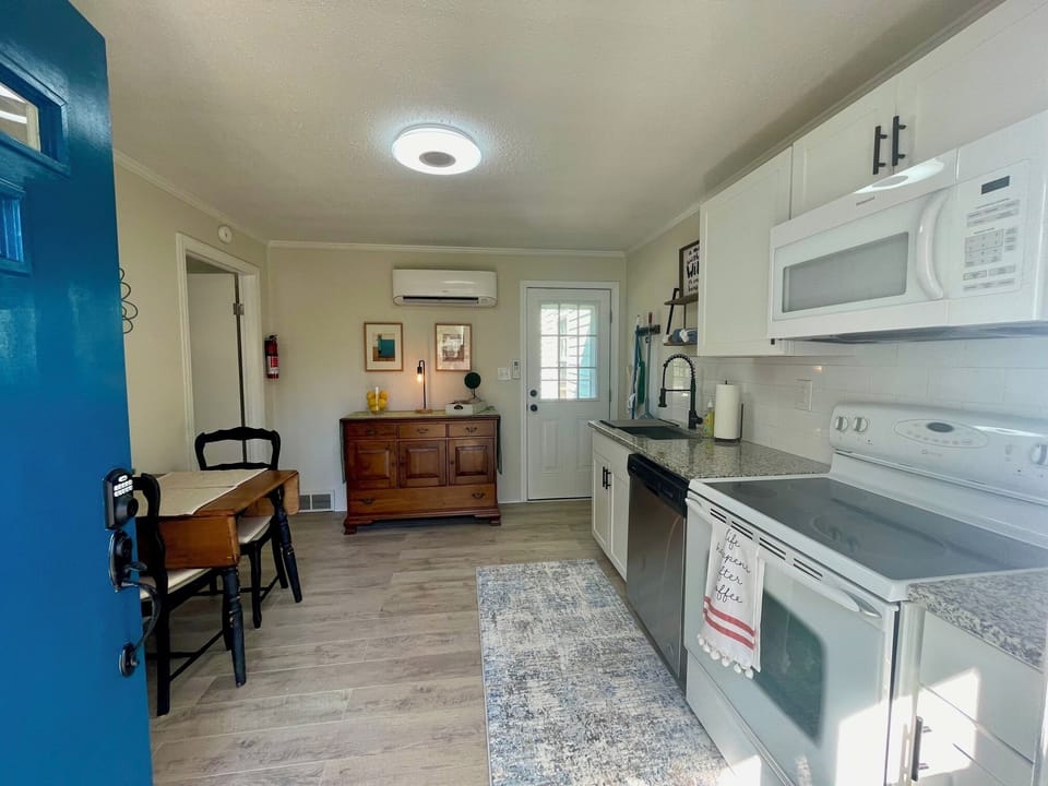 Stocked kitchen with microwave, range/oven, refrigerator, laundry. coffee maker